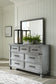 Russelyn King Storage Bed with Mirrored Dresser and Chest